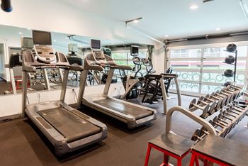 a gym with cardio equipment and chairs in a room with windows at Notch 8, Tacoma, WA, 98444